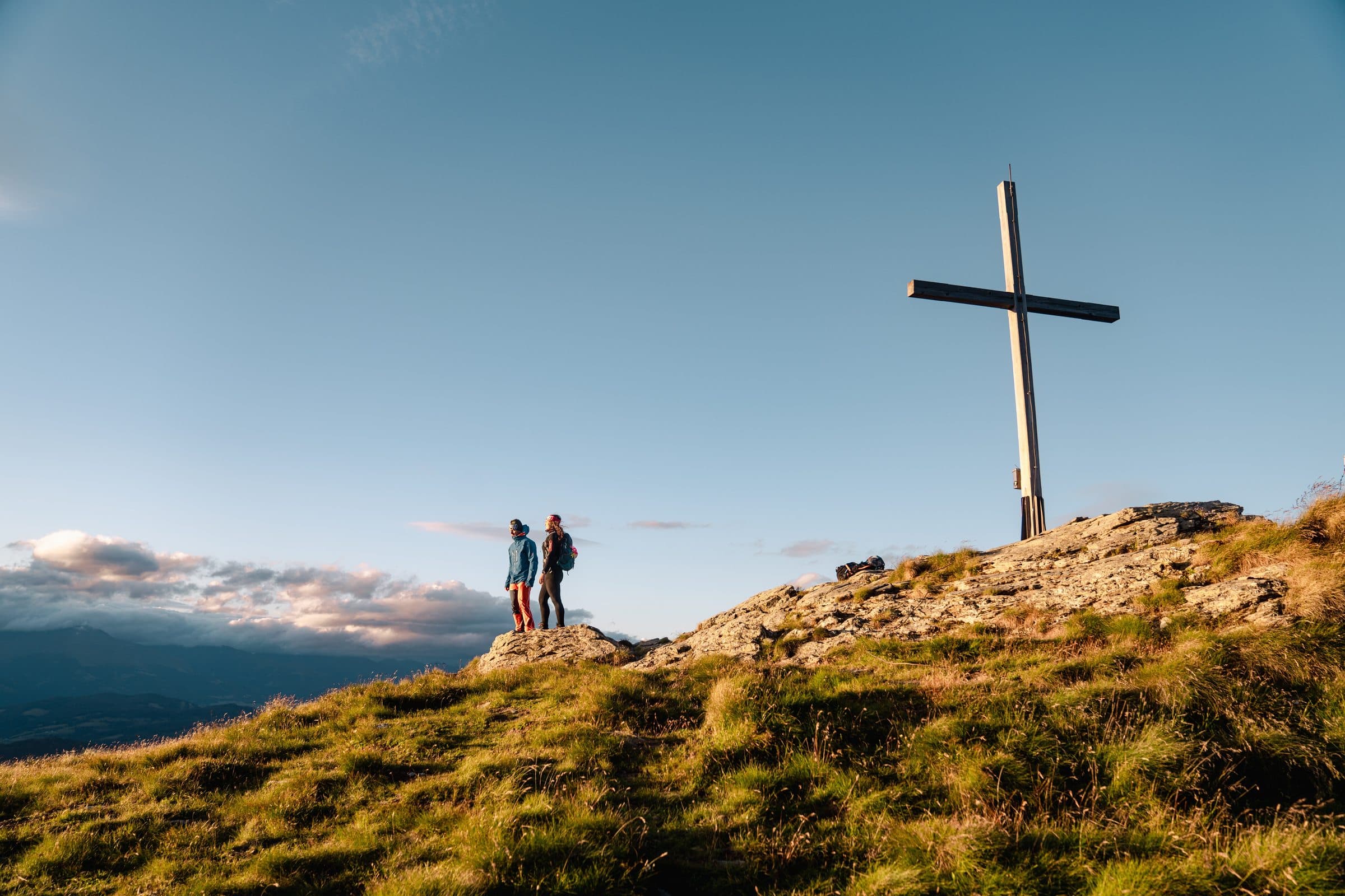 Hiking, silhouette at the summit cross at sunset, Frauenalpe